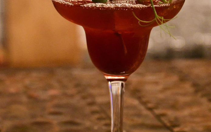 Icelandic cocktail with garnish in exclusive restaurant setting.