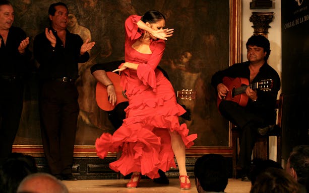 Flamenco dancer performing at Corral de la Morería with musicians in Madrid.