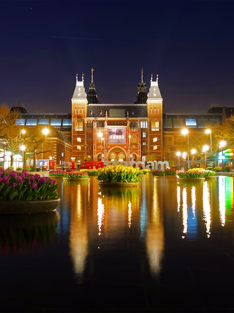Rijksmuseum at night with tulip reflections in Amsterdam.
