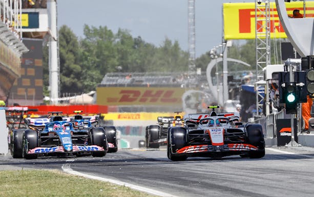 Formula 1 cars racing on the track in Barcelona.