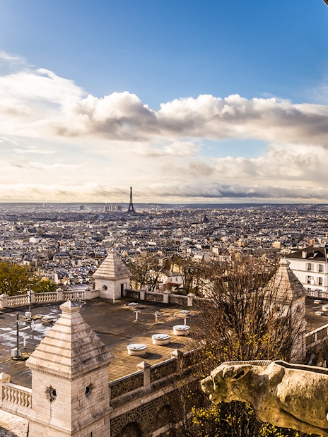 View of Paris skyline from Sacré Coeur Basilica, featuring Eiffel Tower in the distance.