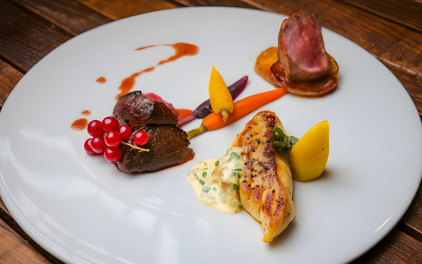 Scottish tasting menu with venison, root vegetables, and sauce at Amber Restaurant.