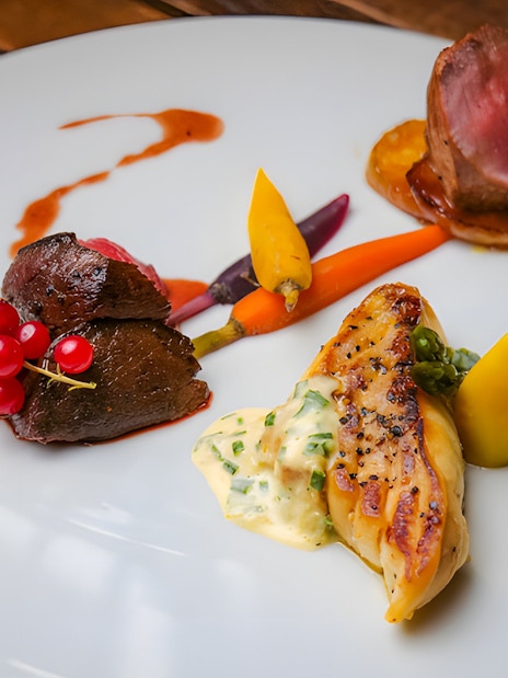 Scottish tasting menu with venison, root vegetables, and sauce at Amber Restaurant.