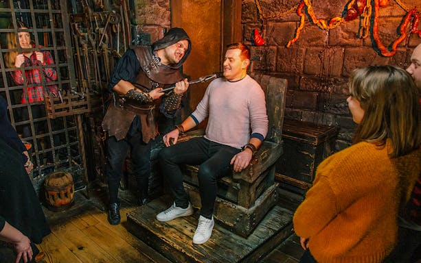 Visitors in the Torture Chamber at Harry Potter Warner Bros. Studio Tour, London Dungeon combo.