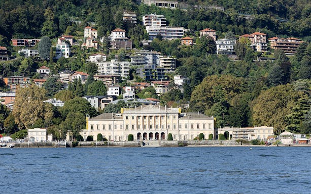 Villa Olmo on Lake Como with hillside houses in the background.