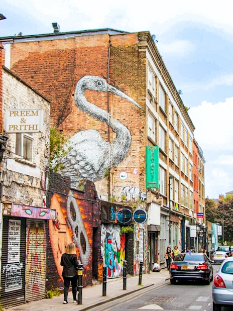 Street art and shops on Brick Lane, London, part of the Shoreditch food tour.