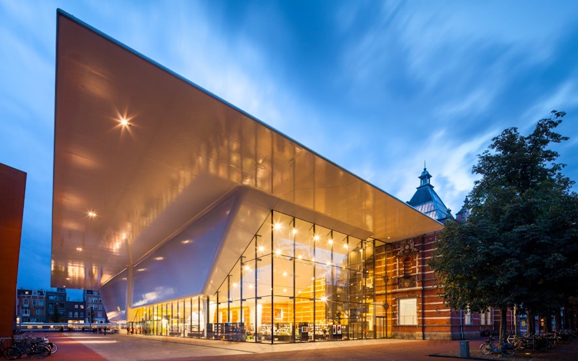 Stedelijk Museum entrance with modern architecture in Amsterdam at dusk.