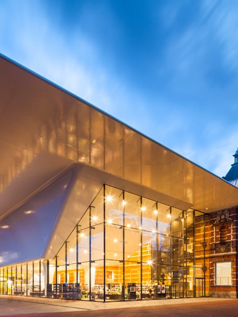 Stedelijk Museum entrance with modern architecture in Amsterdam at dusk.