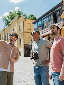 Tourists exploring a historic street in Dubai, enjoying a guided tour.