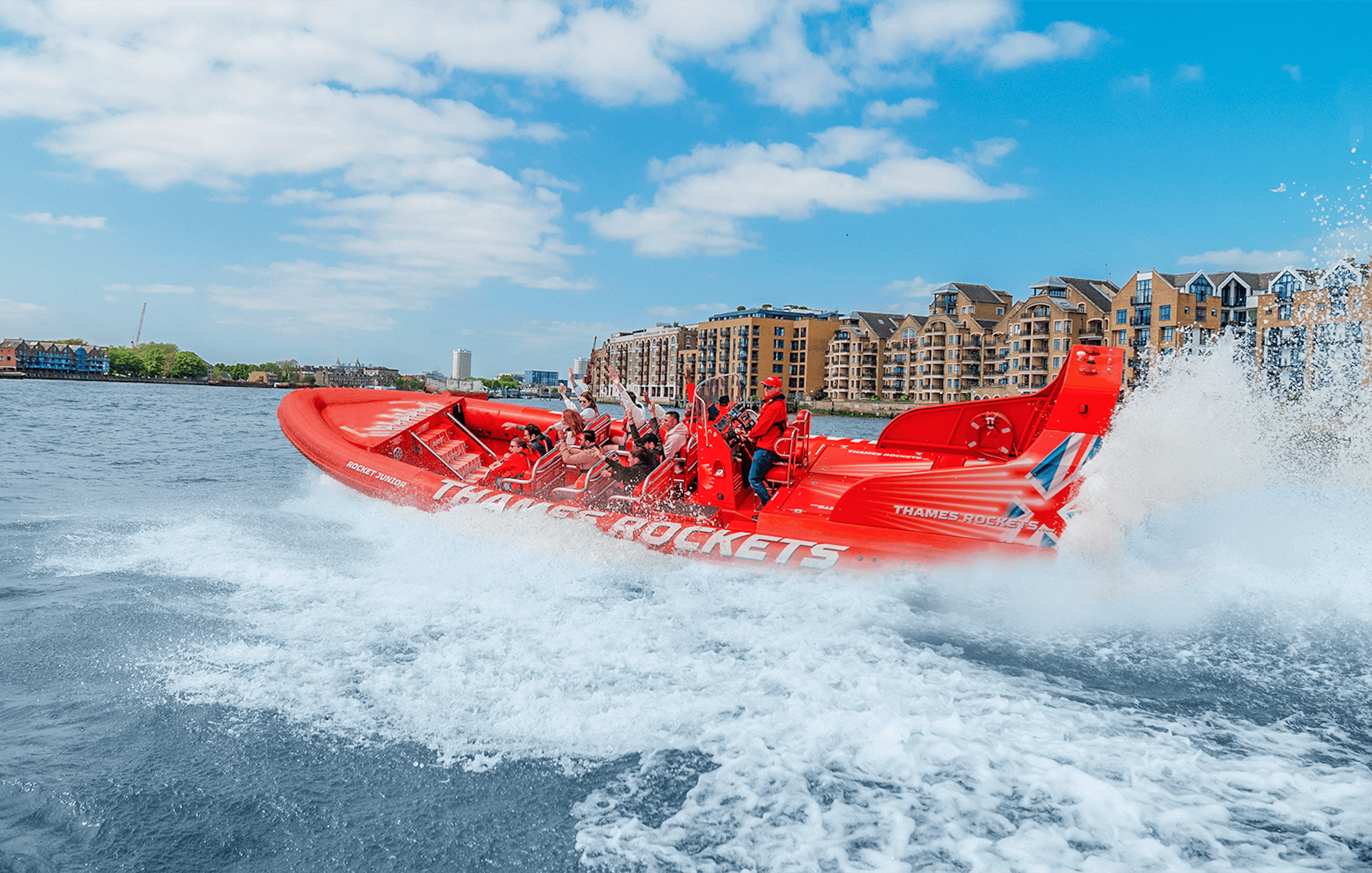Speed boat on the Thames River with passengers enjoying the ride, London.
