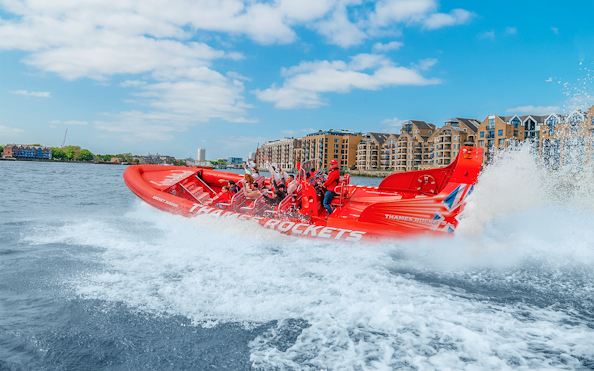 Speed boat on the Thames River with passengers enjoying the ride, London.