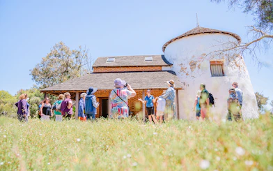 Tour group exploring historic building on Murray River Lunch Cruise.