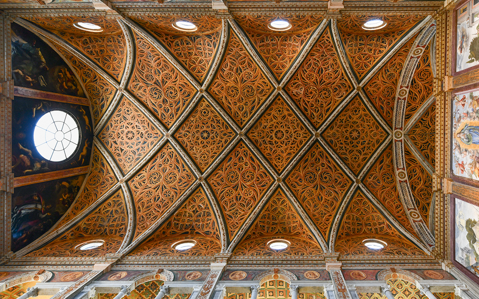 Gothic architecture style ceiling with intricate ribbed vaults in a historic European cathedral.
