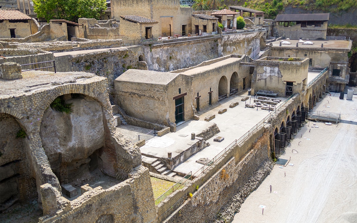 Ancient ruins of the Herculaneum Samnite House with stone arches and preserved structures.