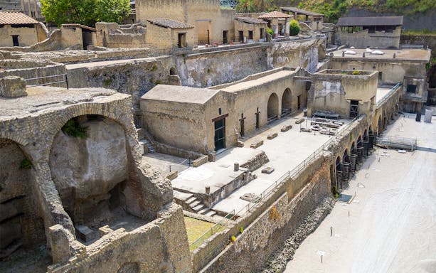 Ancient ruins of the Herculaneum Samnite House with stone arches and preserved structures.