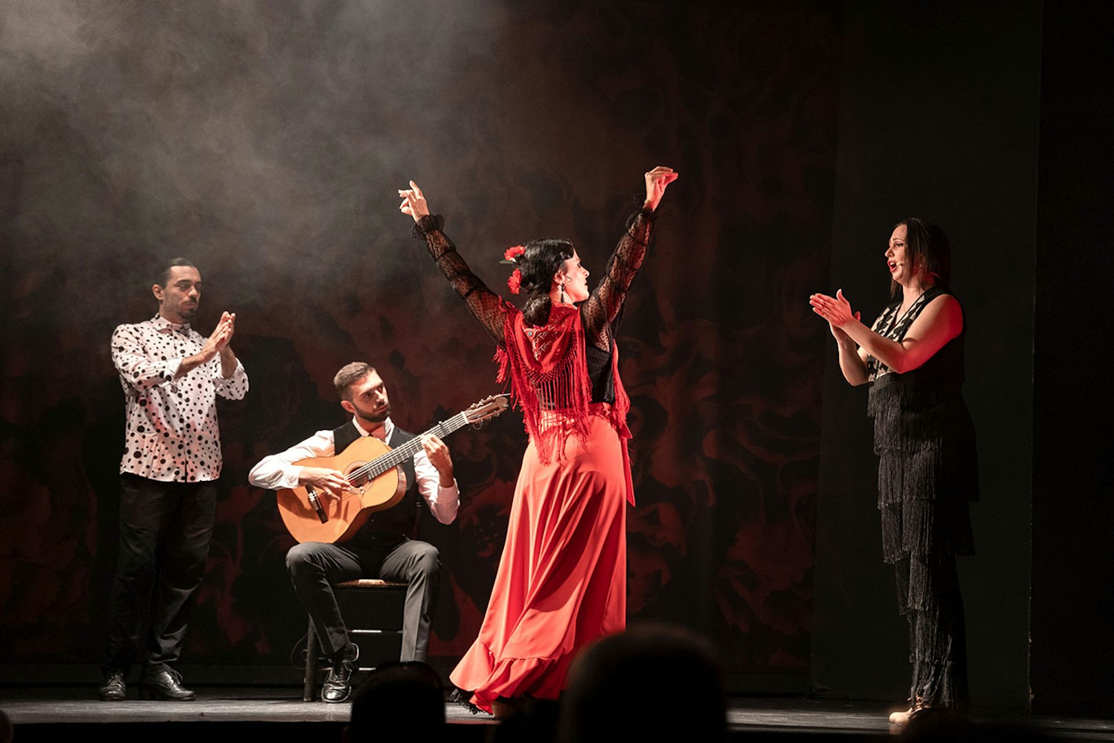 Flamenco dancer performing with musicians at Teatro Flamenco Barcelona.