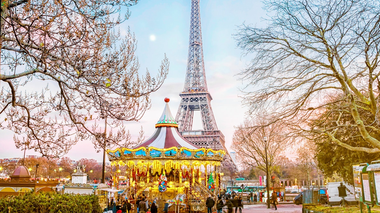 Carousel near Eiffel Tower during Christmas evening in Paris.