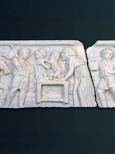 Early Christian marble sarcophagus fragment depicting biblical scenes with figures and animals.
