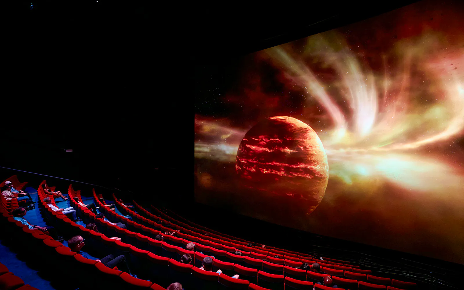 Planetarium show at Cité de l’Espace, France, featuring a cosmic scene on a large screen.