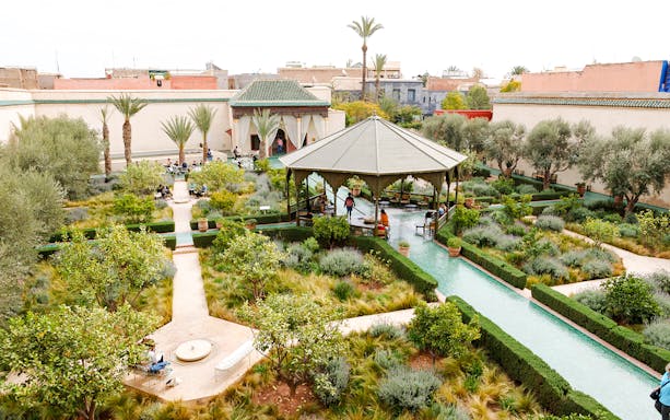 Jardin Secret in Marrakech, Morocco, featuring lush gardens, pathways, and a central pavilion.