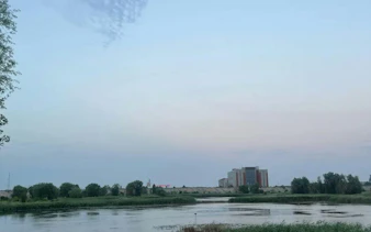 Cretaceous Delta view in Văcărești Nature Park, Bucharest, with distant buildings and greenery.