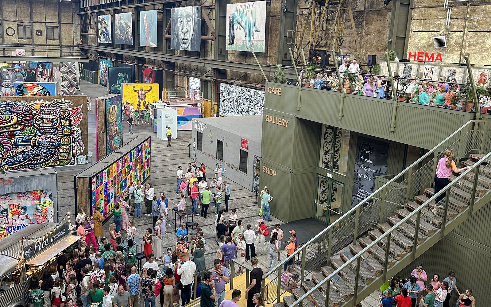 Visitors exploring vibrant street art displays inside Straat Museum, Amsterdam.