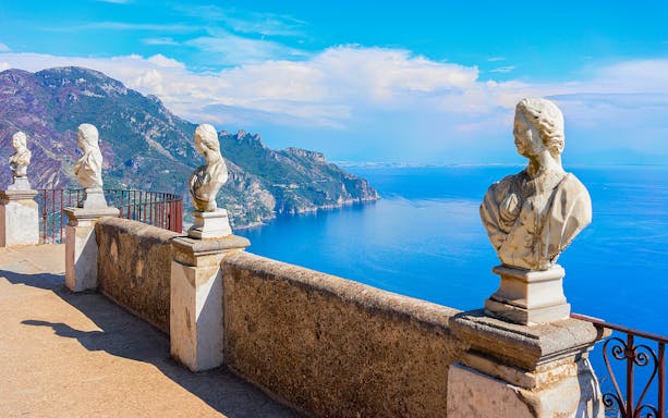 Terrace with marble statues overlooking the Amalfi Coast in Ravello, Italy.
