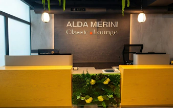 Alda Merini Classic Lounge reception desk at Malpensa Airport Terminal 2, Milan.