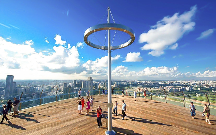 Visitors enjoying the view from Marina Bay Sands SkyPark Observation Deck, Singapore.