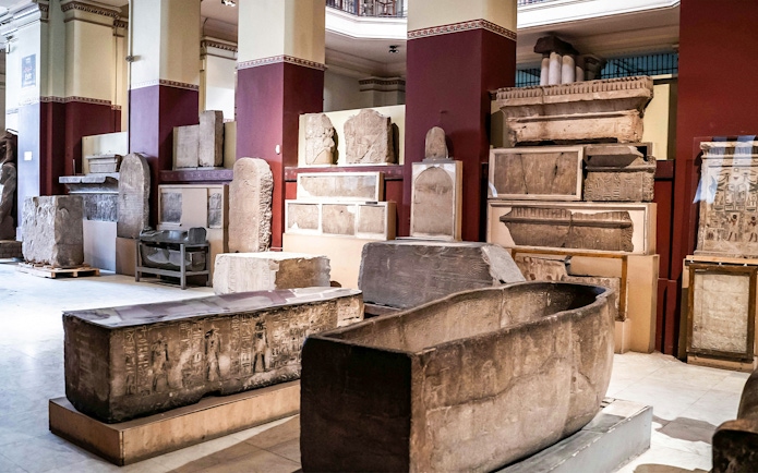 Artifacts and sarcophagi displayed in the Grand Egyptian Museum.