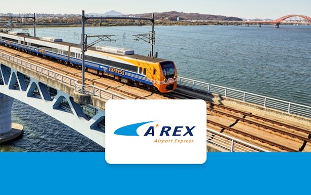 AREX Express train crossing a bridge over water between Incheon Airport and Seoul.
