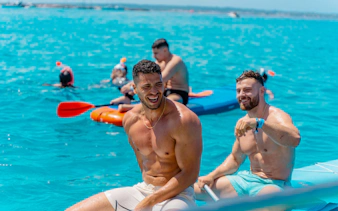 Friends enjoying kayaking and snorkeling during Formentera Cruise Tour.