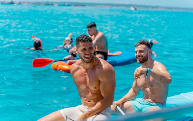 Friends enjoying kayaking and snorkeling during Formentera Cruise Tour.