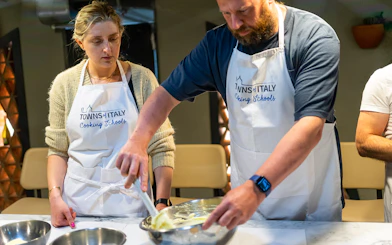 Cooking class participants preparing pasta in Milan.