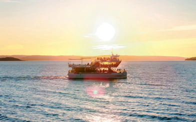Dinner cruise boat sailing at sunset near Stavanger.
