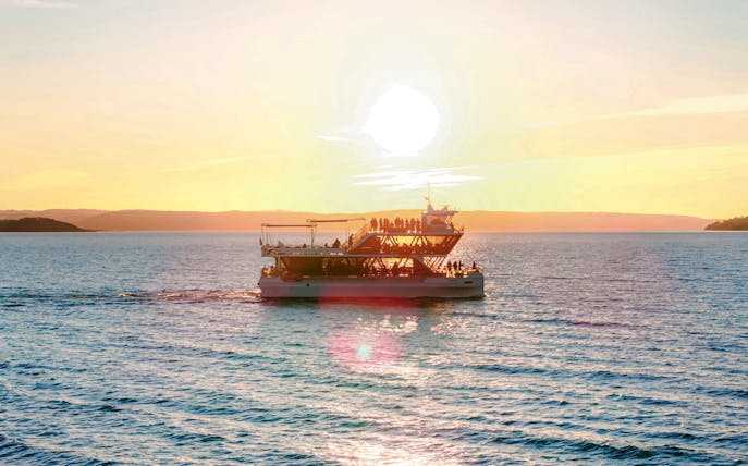 Dinner cruise boat sailing at sunset near Stavanger.