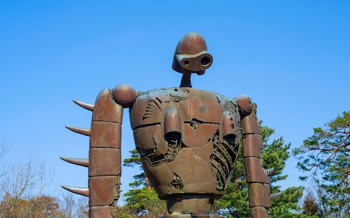 Robot statue at Studio Ghibli Museum in Japan under clear blue sky.