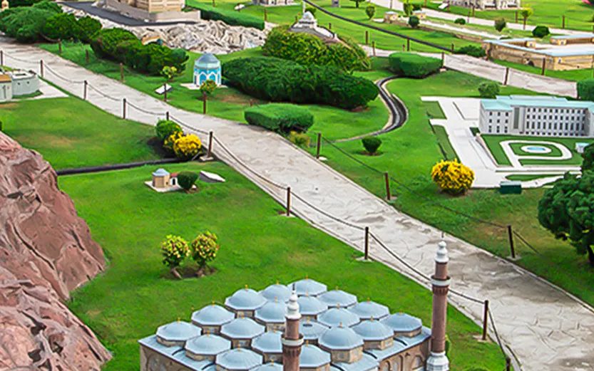 Miniature park with model of Selimiye Mosque in Istanbul, Turkey, surrounded by greenery and pathways.