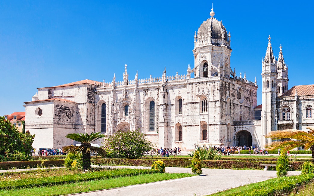 Jerónimos Monastery with ornate architecture and gardens in Lisbon, Portugal.