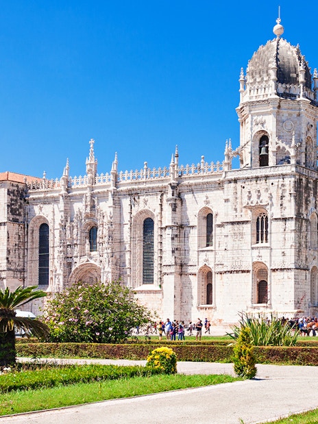Jerónimos Monastery with ornate architecture and gardens in Lisbon, Portugal.