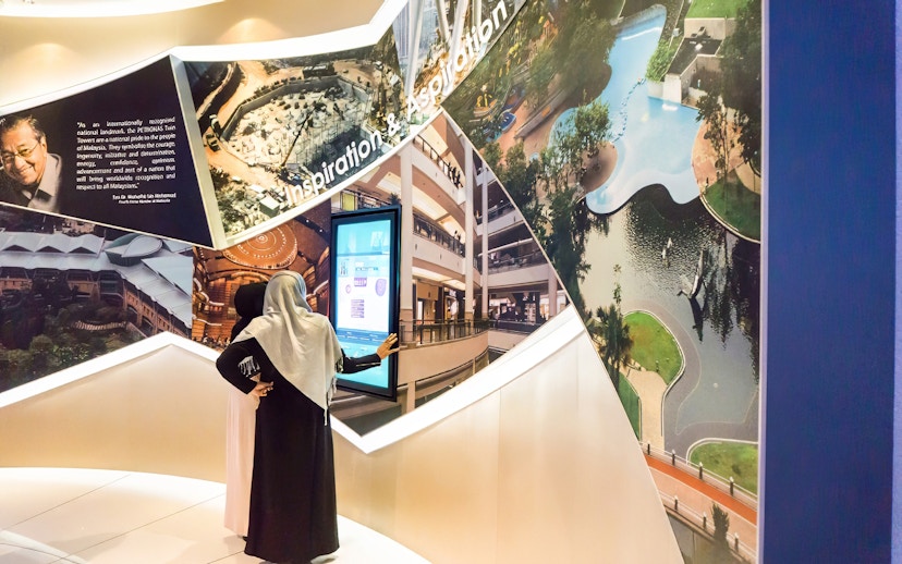Visitors exploring Petronas Twin Towers exhibit in Kuala Lumpur.