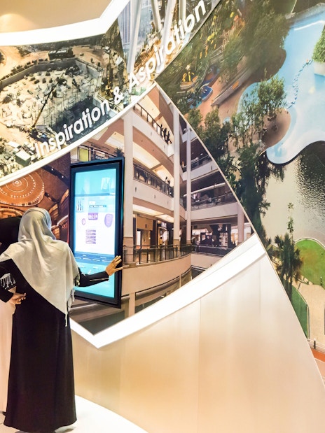 Visitors exploring Petronas Twin Towers exhibit in Kuala Lumpur.
