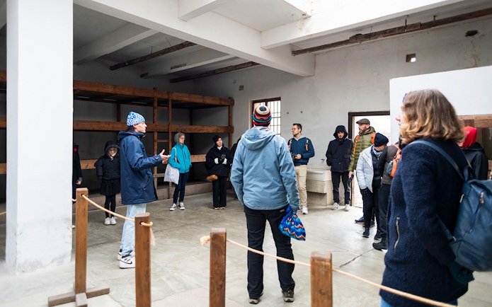 Guests touring a room inside Terezin Concentration Camp.