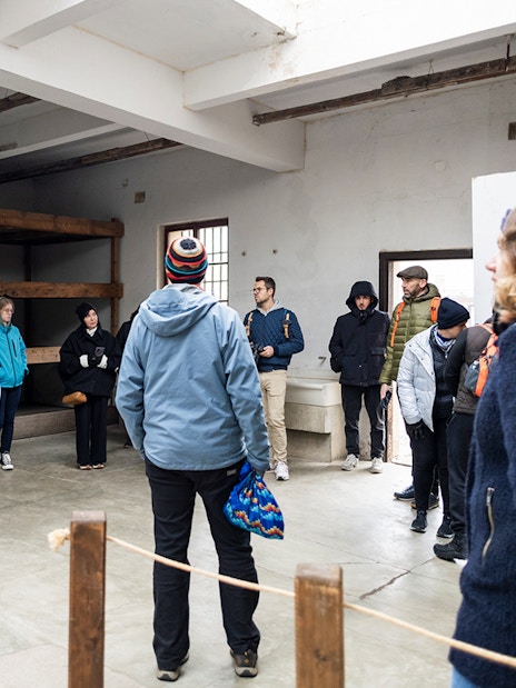 Guests touring a room inside Terezin Concentration Camp.