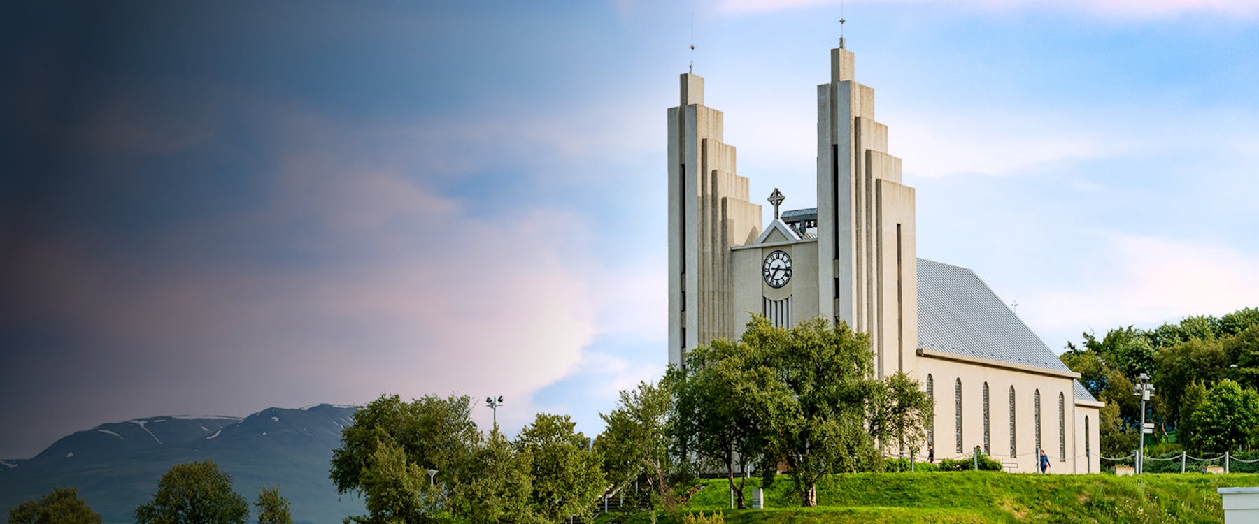Akureyri Church with mountain backdrop in Akureyri, Iceland.