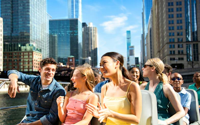 Group enjoying Sea Dog Cruise on Lake Michigan with Chicago skyline in background.