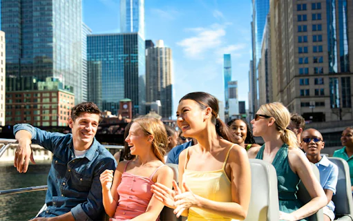 Group enjoying Sea Dog Cruise on Lake Michigan with Chicago skyline in background.