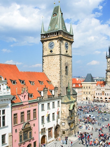 Prague Astronomical Tower with weekend crowd in Old Town Square.