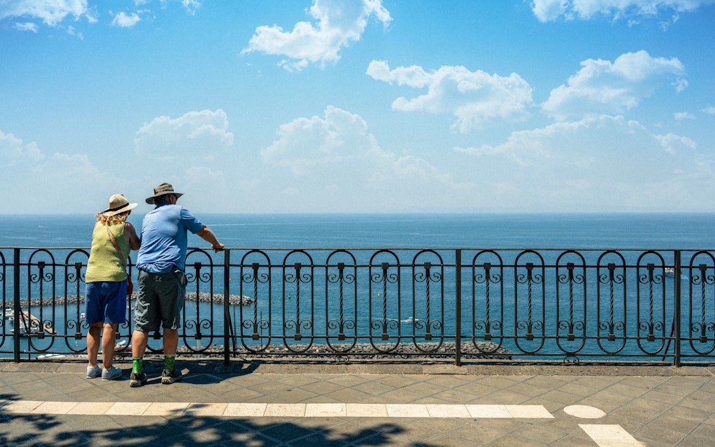 Couple admiring the Bay of Naples from a scenic overlook.