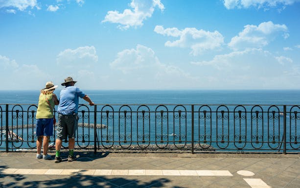 Couple admiring the Bay of Naples from a scenic overlook.